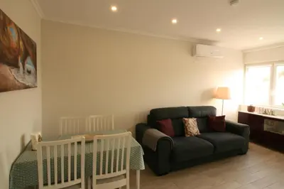 a living room with a couch and a baby crib at Downtown Dreams in Faro