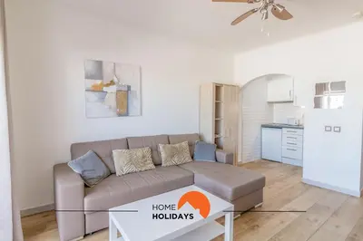 a living room with a couch and a kitchen at #057 T1 Rossio 43D by Home Holidays in Albufeira