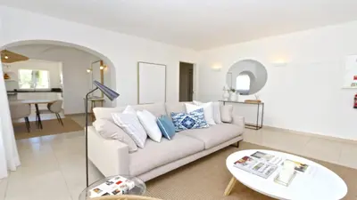 a living room with a white couch and a table at Vila Chez Lee, 219 Aldeia do Golf-CleverDetails - Sleeps 6, quiet area in Vilamoura