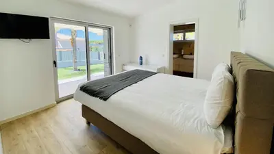 a bedroom with a bed and a couch and a window at Moderna by Check-in Portugal in Quarteira