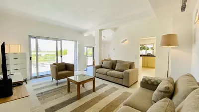 a living room with a couch and a table at Moderna by Check-in Portugal in Quarteira