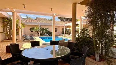 a patio with a table and chairs and a pool at Seventies by Check-in Portugal in Quarteira