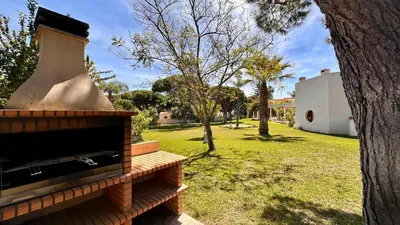 a vase sitting on a bench next to a tree at Seventies by Check-in Portugal in Quarteira