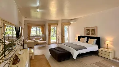 a bedroom with a bed and a living room at Seventies by Check-in Portugal in Quarteira