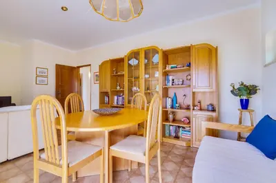 a kitchen and dining room with a table and chairs at InfiniteSeaView - Quarteira at Homesbyfc in Quarteira
