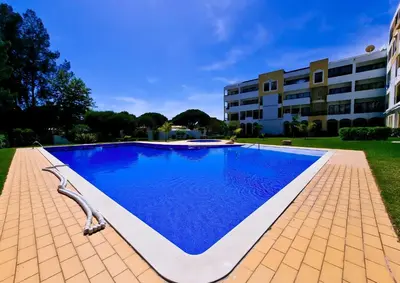 a swimming pool in front of a building at FLH Vilamoura Summer Flat with Pool in Vilamoura