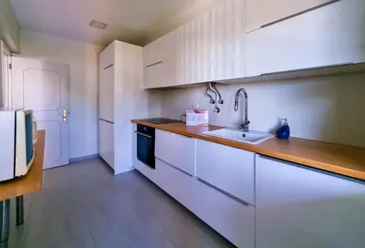 a kitchen with white cabinets and a sink at FLH Vilamoura Summer Flat with Pool in Vilamoura