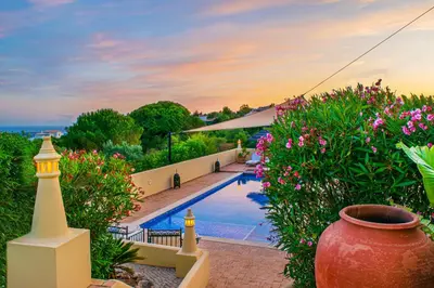 a villa with a swimming pool and some flowers at Casa Lusitania 19 in Faro