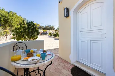 a table with food on it next to a door at Casa Lusitania 19 in Faro