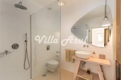 a bathroom with a shower and a toilet and a sink at Elegant villa with private pool in Quarteira in Vilamoura