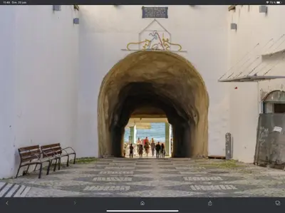 a group of people walking through a tunnel in a building at Beira mar in Albufeira
