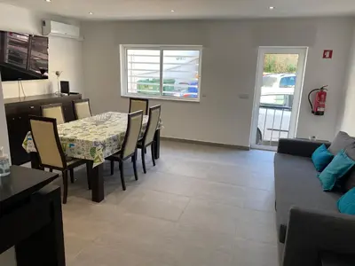 a kitchen and dining room with a table and chairs at Beira mar in Albufeira