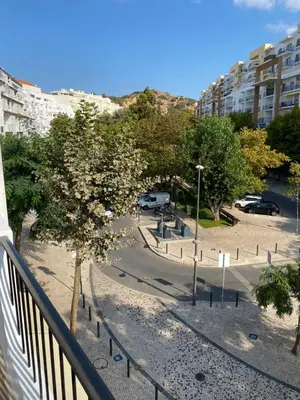 a view of a park with trees and buildings at Beira mar in Albufeira