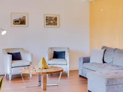 a living room with two chairs and a table at L'orangerie modern 1bdr apartment, ground floor in Vilamoura
