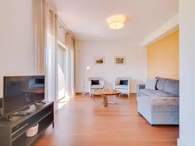 a living room with a couch and a table at L'orangerie modern 1bdr apartment, ground floor in Vilamoura