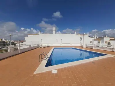 a large swimming pool on the roof of a building at Appartement T1 Albufeira Strip Oura in Albufeira
