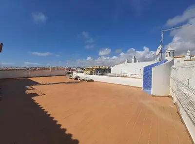 a large patio on top of a building at Appartement T1 Albufeira Strip Oura in Albufeira