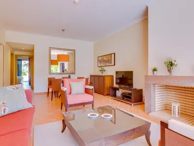 a living room with a couch and a fireplace at AL - Apartamento Vila Sol F5 L in Vilamoura
