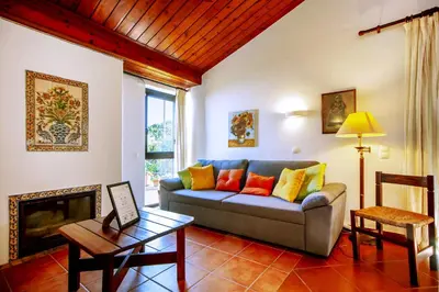 a living room with a couch and a fireplace at LOTUS VILLA 2, ALBUFEIRA in Albufeira
