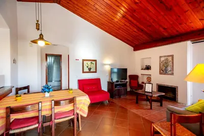 a living room with a table and chairs and a couch at LOTUS VILLA 2, ALBUFEIRA in Albufeira