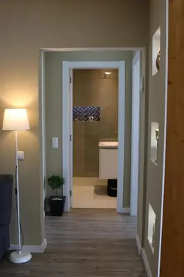 a living room with a wooden partition with shelves on the wall at RS Apartamento in Quarteira