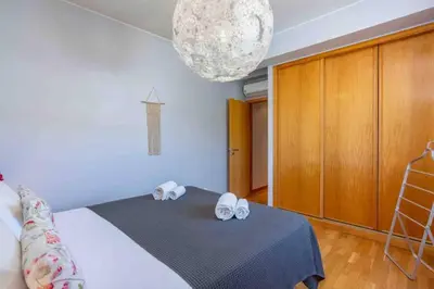 a bedroom with a bed with two towels on it at Admirable 1 bedroom Marina view apt. Albufeira in Albufeira