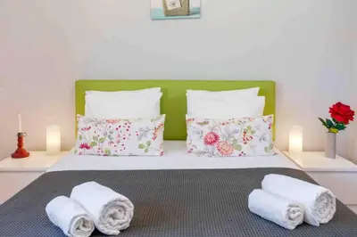 a bedroom with a bed with towels on it at Admirable 1 bedroom Marina view apt. Albufeira in Albufeira
