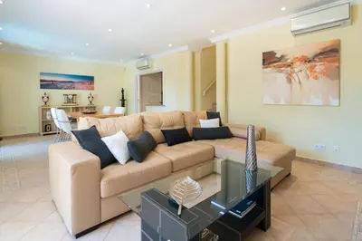 a living room with a couch and a table at Vale de Lobo by Intiholidays in Vale do Lobo