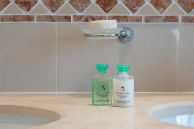 two bottles of soap sitting on a counter next to a sink at Vale de Lobo by Intiholidays in Vale do Lobo
