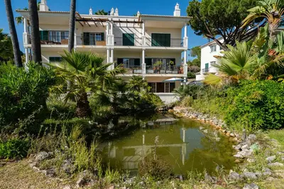 a building with a pond in front of it at Vale de Lobo by Intiholidays in Vale do Lobo