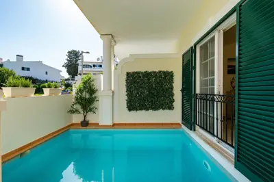 a house with a swimming pool on a balcony at Vale de Lobo by Intiholidays in Vale do Lobo