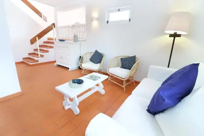 a living room with a white couch and chairs at Seagull Rooftop Beach @150 m in Vale do Lobo