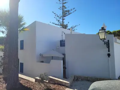 a white building with a tree and a street light at Seagull Rooftop Beach @150 m in Vale do Lobo