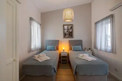 two twin beds in a room with a light at Casa Estrela do Mar in Vale do Lobo