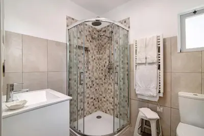 a bathroom with a shower and a sink and a toilet at Casa Harlequin in Vale do Lobo