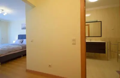 a room with a bedroom with a bed and a mirror at Perfect New Apartment in Albufeira in Albufeira