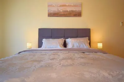 a bedroom with a large bed with two lamps at Perfect New Apartment in Albufeira in Albufeira