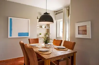 a dining room with a wooden table and chairs at Villa Apple in Vale do Lobo
