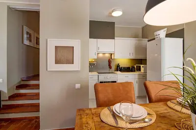 a kitchen and dining room with a table and chairs at Villa Apple in Vale do Lobo