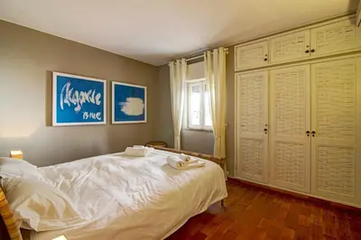 a bedroom with a large white bed and a window at Villa Apple in Vale do Lobo