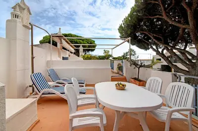 a white table and chairs on a balcony at Villa Apple in Vale do Lobo