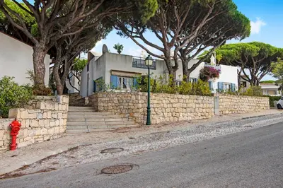 a red fire hydrant in front of a brick wall at Villa Apple in Vale do Lobo