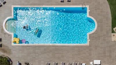 an overhead view of a swimming pool with people in it at Aveiros by the Sea by Intiholidays in Albufeira