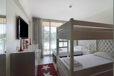 a bedroom with two bunk beds and a television at Salgados 4seasons Apartment in Albufeira