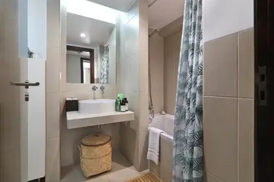 a bathroom with a sink and a mirror at Salgados 4seasons Apartment in Albufeira