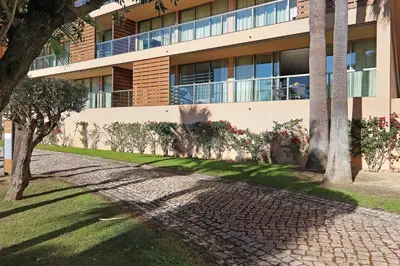 a building with a sidewalk in front of it at Salgados 4seasons Apartment in Albufeira