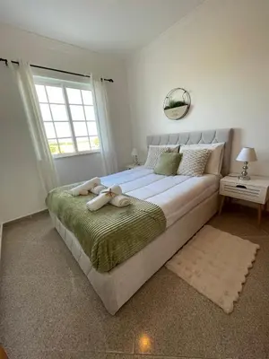 a bedroom with a large bed with a window at Villa Sunshine in Albufeira