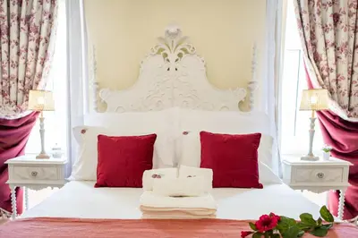 a bedroom with a white bed with red pillows at 7 Styles Apartments by Raspberry Cascade in Faro