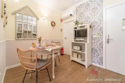 a dining room with a table and a microwave at 7 Styles Apartments by Raspberry Cascade in Faro