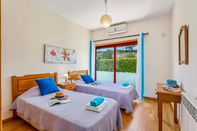 two beds in a room with a window at Villa Marina Azul by Villa Plus in Albufeira